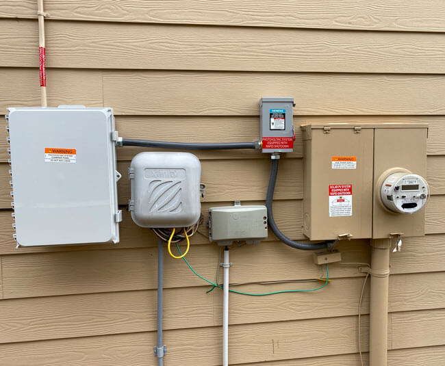 Residential solar electrical meter and disconnect equipment on exterior wall in Atlanta, GA
