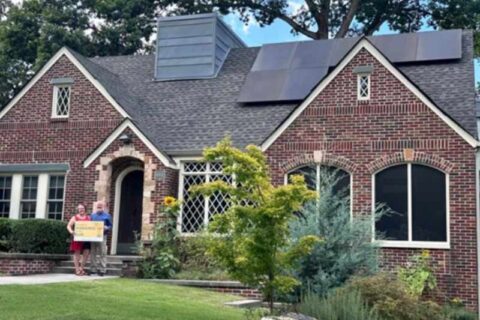 Happy customers standing by their new solar panel system in Atlanta, GA